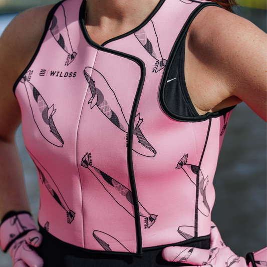 Pink neoprene body warmer with black whale pattern